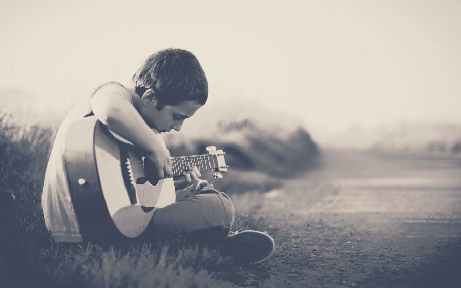 kid playing Acoustic Guitar