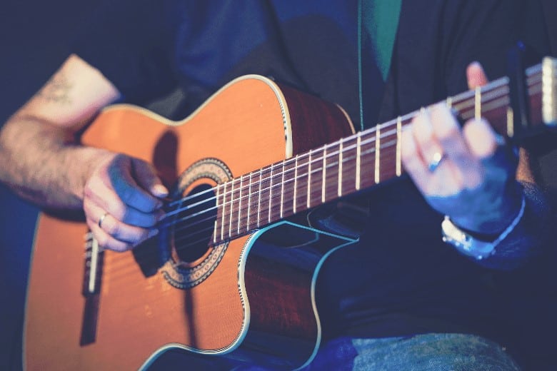 man playing cutaway blues guitar