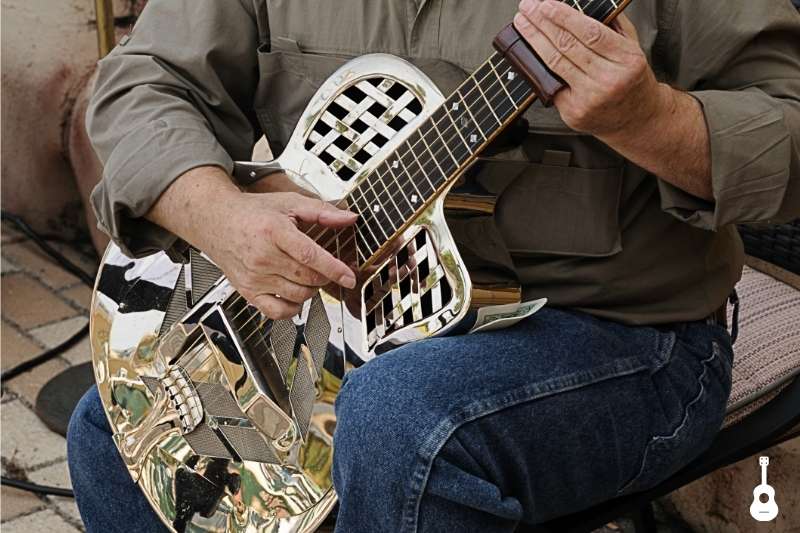 Guitarist playing with ceramic guitar slide