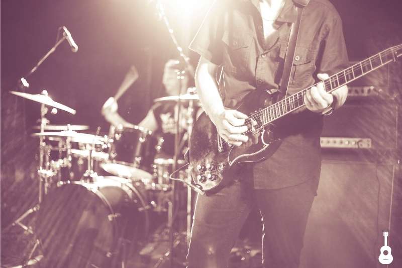 Tall Guitarist Playing Electric Guitar on Stage