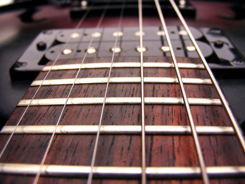 set of thicker guitar strings on an electric guitar