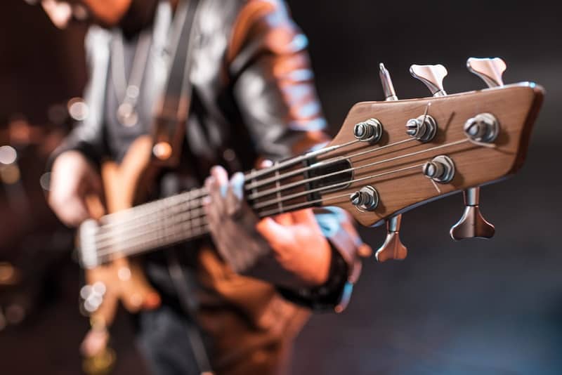 man playing 5 string bass guitar 6 21