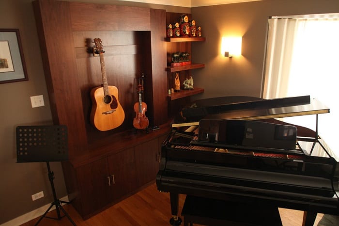 music room with wooden furniture and piano
